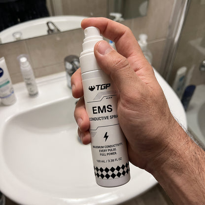 Holding the TGP EMS Conductive Spray bottle